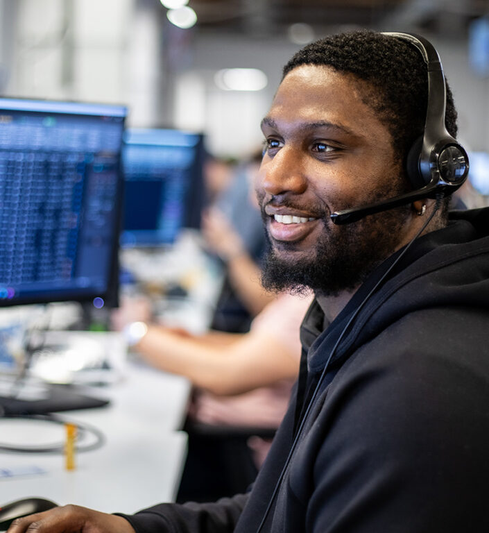 A Roadtex expert sitting at his work station with a headset on