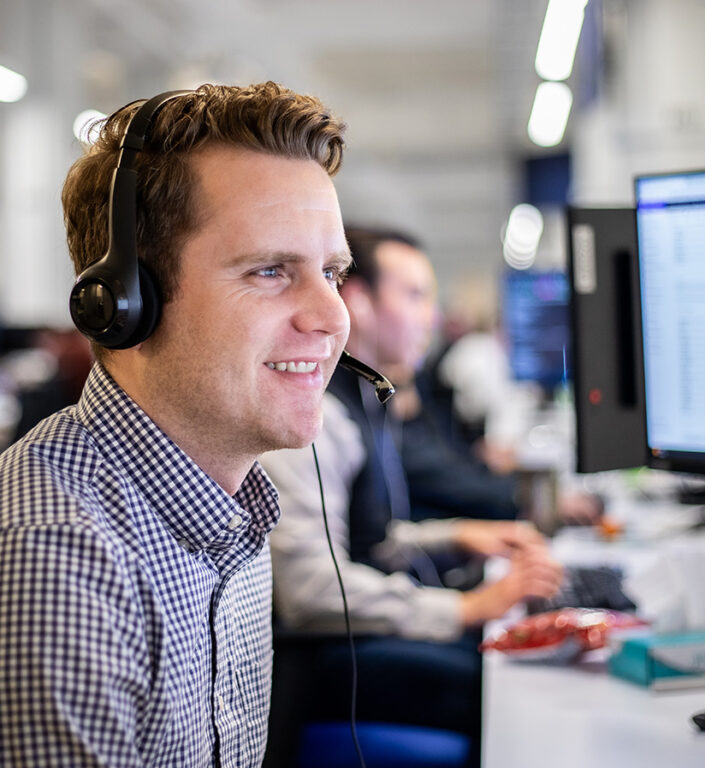 A Roadtex employee with a headset on working on shipping clients freight.