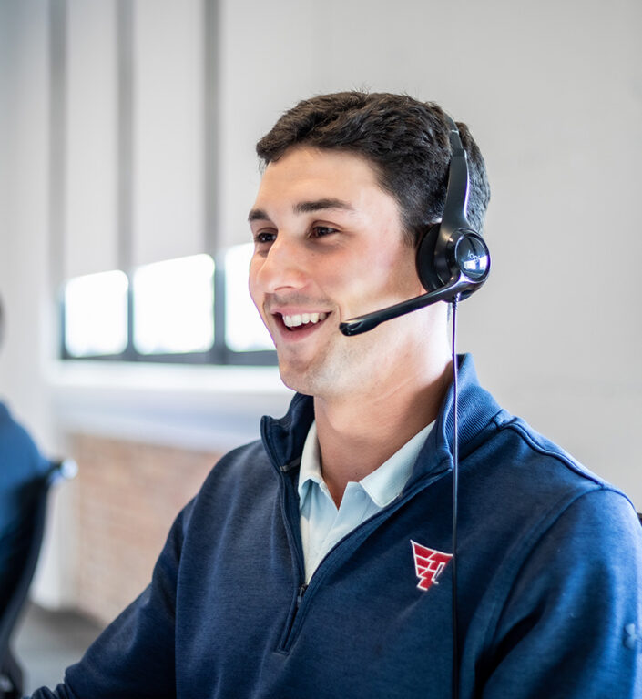 A Roadtex expert sitting at their work station with a headset on,