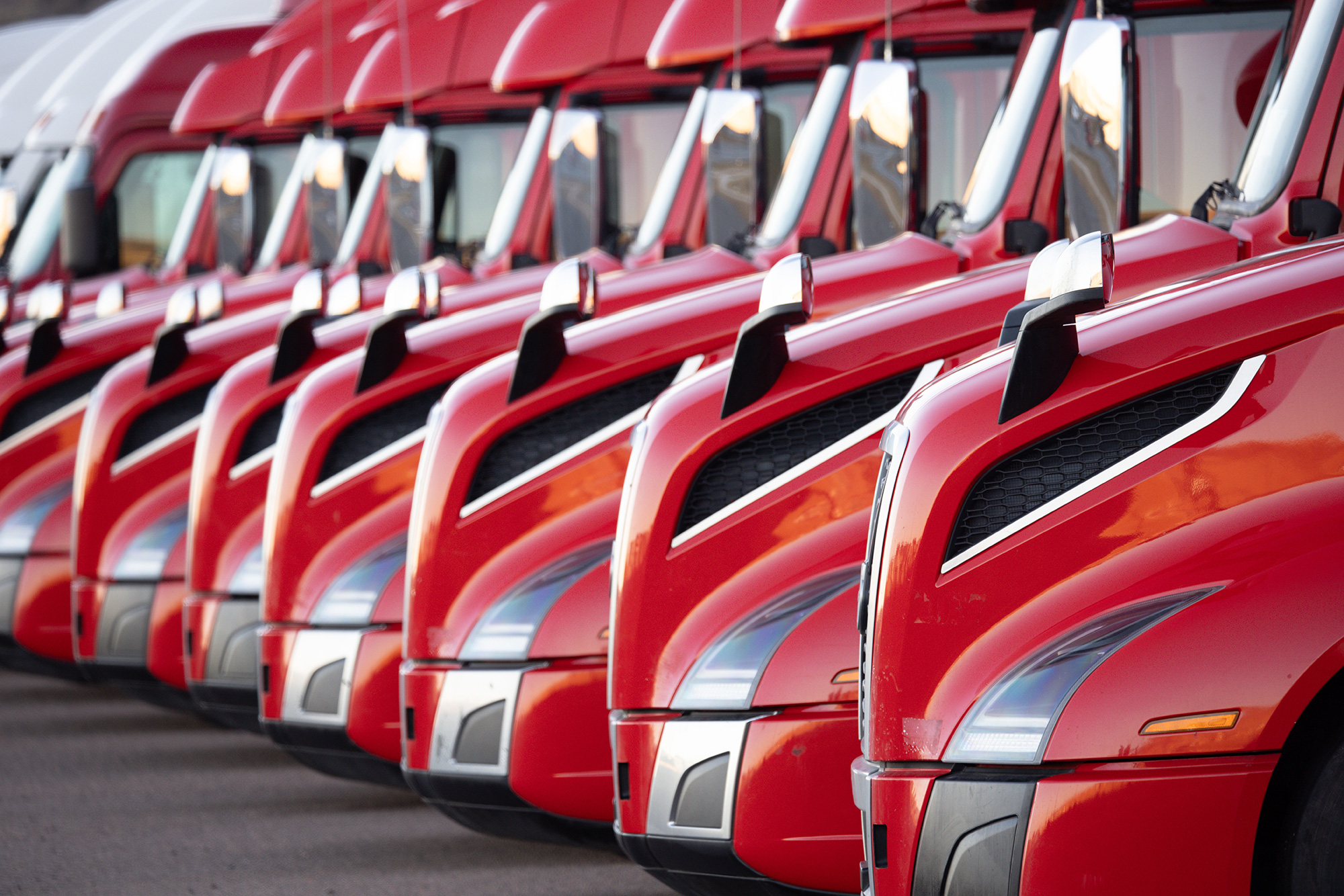 Red semi trucks lined up diagonally.