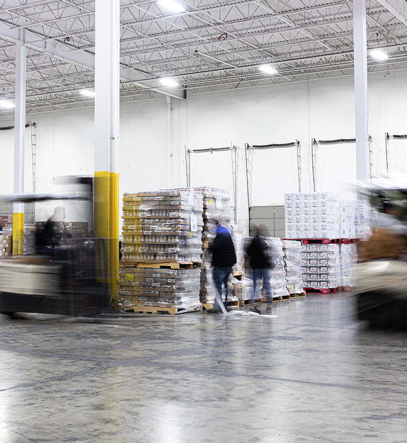 Workers inside one of Roadtex's warehouses moving around product.