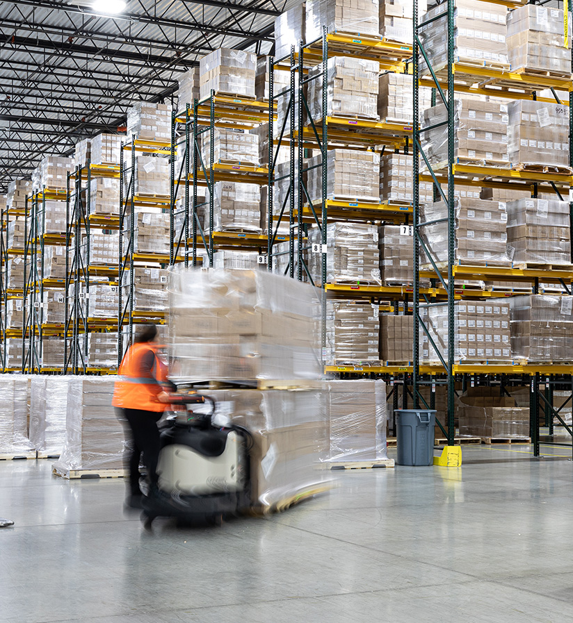 Roadtex warehouse workers moving around product inside Roadtex's warehouse.