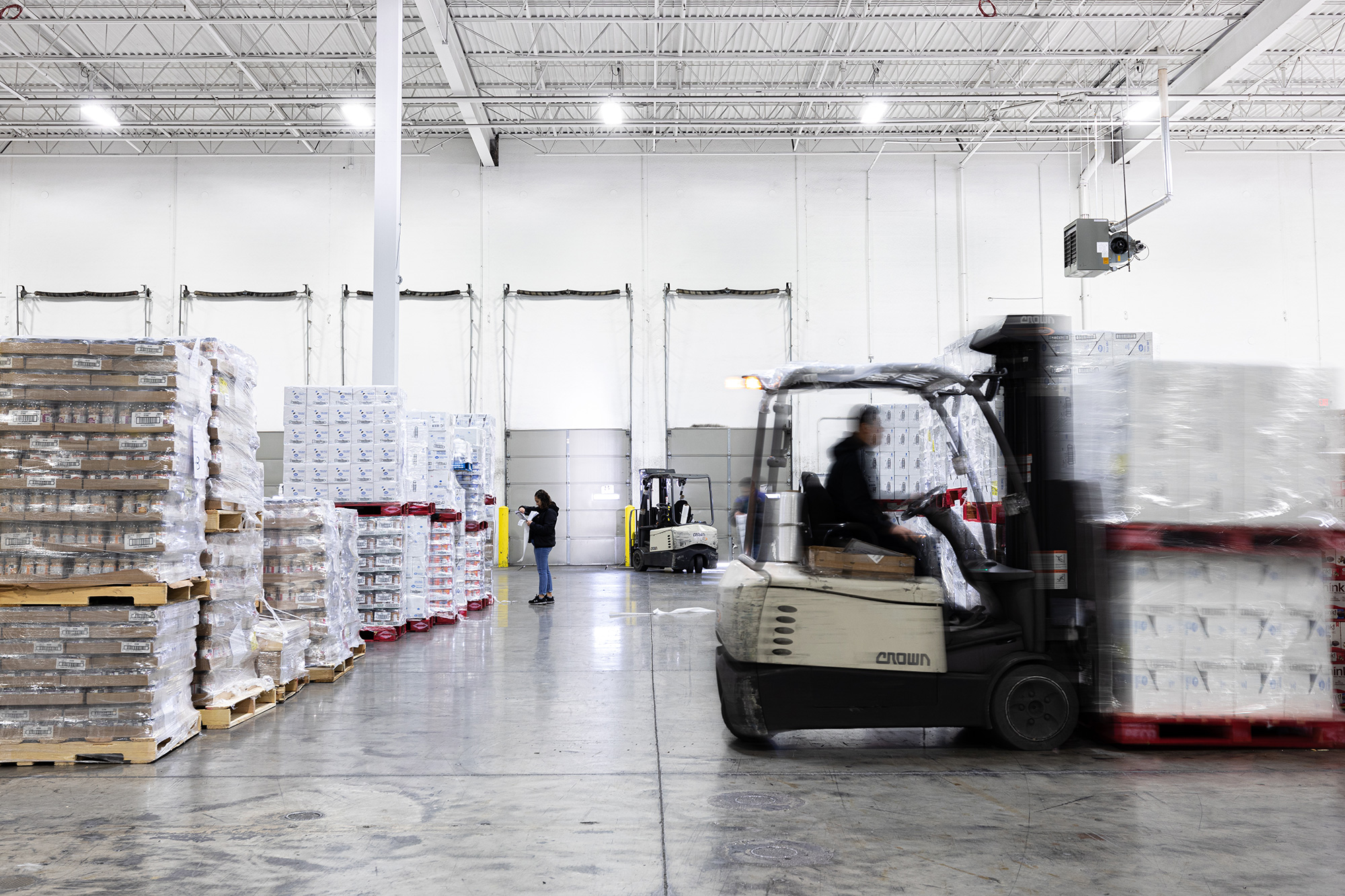 Roadtex warehouse employees moving merchandise around with a forklift.