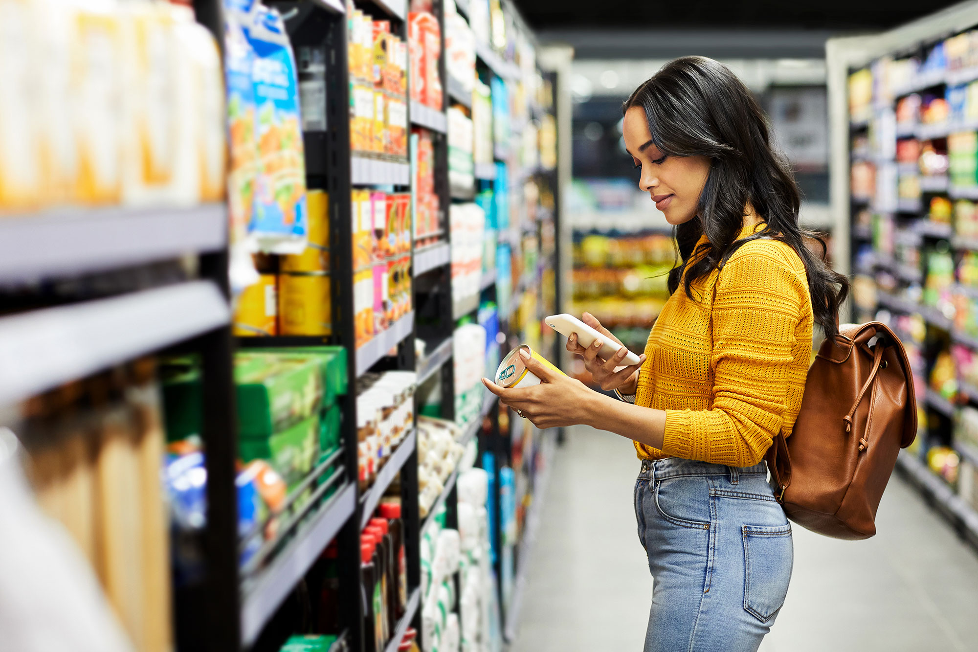 A women shopping for produce in a grocery store.