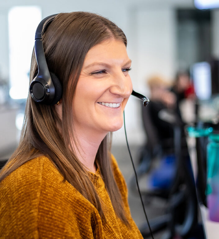 A Roadtex expert sitting at her work station with a headset on