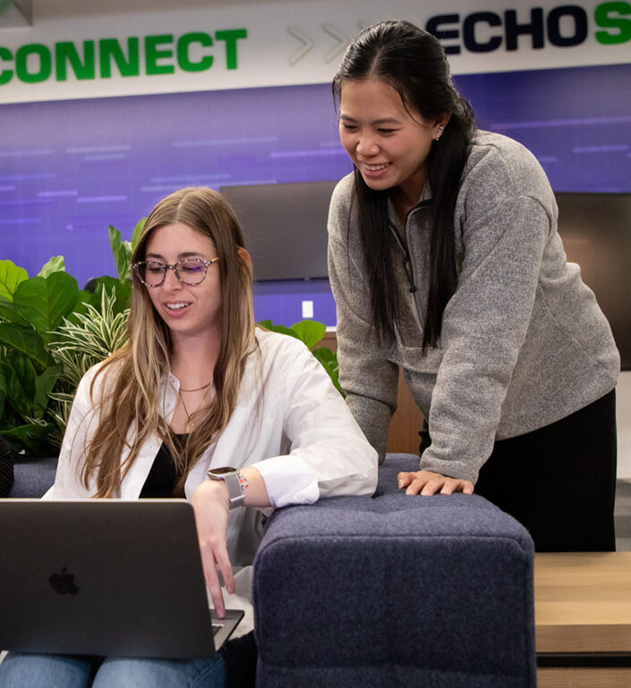 Three Roadtex employees working together on a laptop.