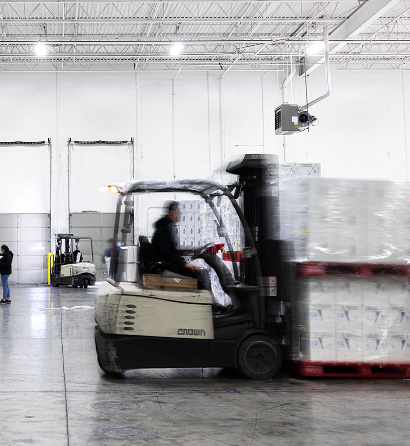 Roadtex warehouse employees moving merchandise around the warehouse using forklifts.